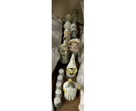 A collection of Royal Worcester candle snuffers including French Cook, Owl, Nun, Feathered Hat, Young Girl, Old Woman, Toddie