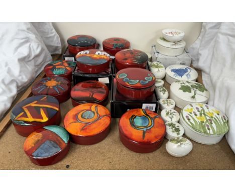 A collection of Poole pottery trinket boxes and covers of circular form patterns including Poppy Field, Volcano, Fantasy, Him