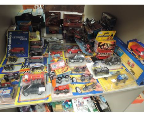 A shelf of mixed vintage Corgi, Matchbox and simar diecasts, all boxed or in blister packs