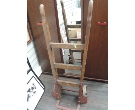 A vintage railway station wooden and cast sack truck