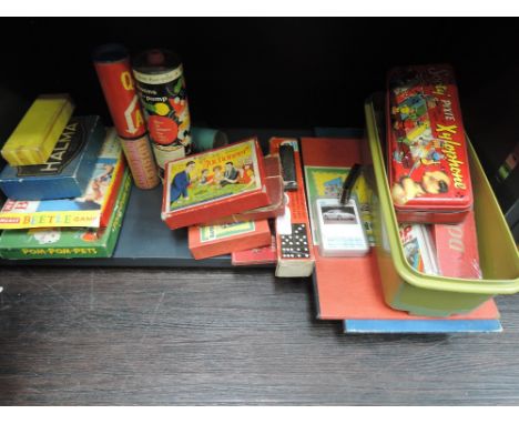 A shelf of vintage games and toys including Top Trumps cards, Sooty Xylophone, Auctioneer etc