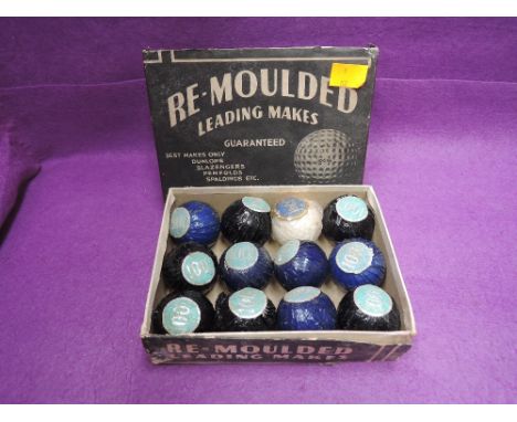 A set of twelve vintage Re-Moulded golf balls, in original wrappers and box