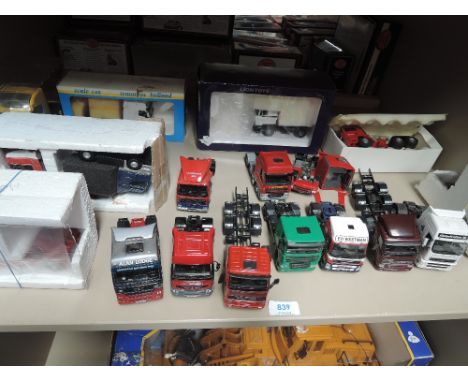 A shelf of mixed diecast tractor units, part boxed