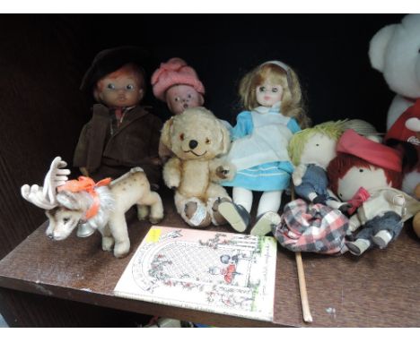 A shelf of mixed vintage dolls and teddy bears including early 20th century bisque, a mid 20th century Merrythought bell in t