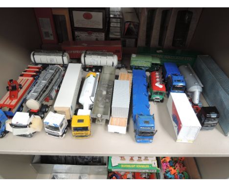 A shelf of mixed diecast articulated wagons and trucks