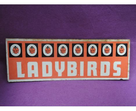 A vintage tin and enamel Ladybirds advertising sign