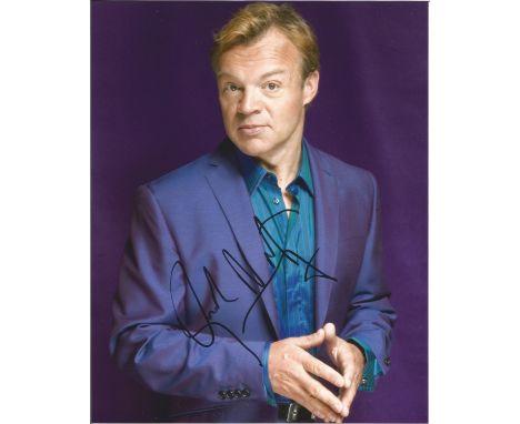 Graham Norton signed 10x8 half body portrait colour photo in purple suit. Good Condition. All signed pieces come with a Certi