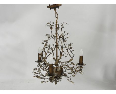 A hanging pressed metal three light electrolier, of foliate form with hanging glass drops, 60cm tall