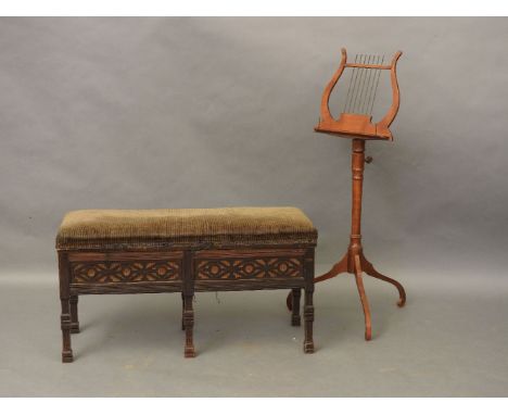 An Edwardian mahogany duet stool, with blind fret detail, and a music stand