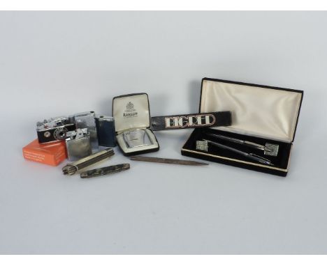 Two boxes of penknives, pens and lighters, including camera lighter, silver pencil etc.