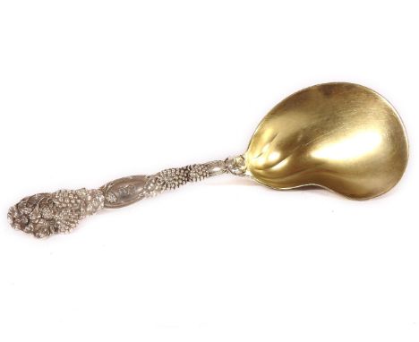 An American Tiffany & Co. sterling silver ladle, with a gilt bowl, monogrammed, with a fruit cast handle, 23.8cm long
