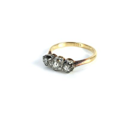 A gold three stone diamond ring, marked 18ct, 2.97g