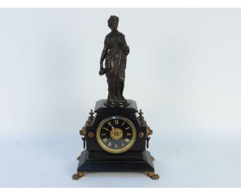 A Victorian black slate mantel clock, surmounted with a bronze figure, the movement stamped ;Marchand of Paris'