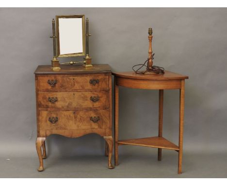 A figured walnut three drawer chest together with a corner table, brass toilet mirror and a walnut table lamp (4)