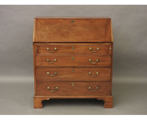 A George III mahogany fall front bureau, fitted with four graduated drawers, on bracket feet