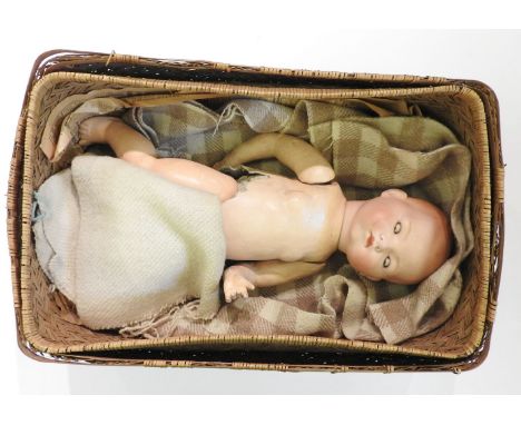 An Armand Marseille baby doll, with a bisque head and papier mâché body, impressed 'AM Germany 341/6/K', body with damage