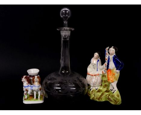 Two Staffordshire groups, one other, and an Edwardian etched glass decanter