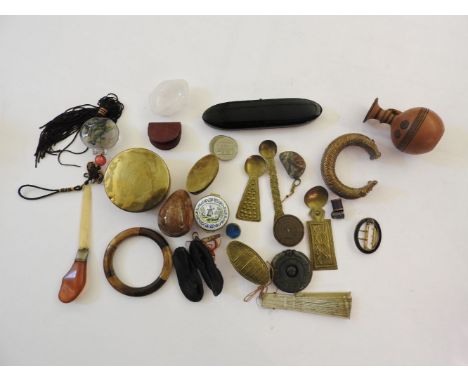 An assortment of collectables, including an African bronze Manilla, other African metalwares, an amber handled letter knife, 