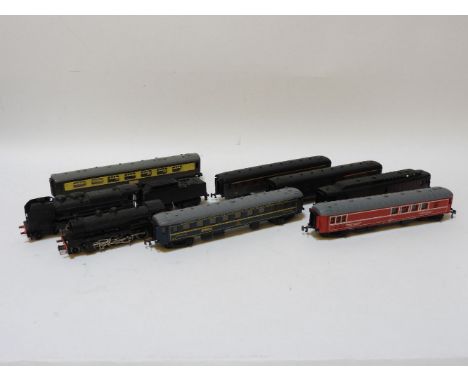 A collection of 00 gauge trains, contained in a painted trunk