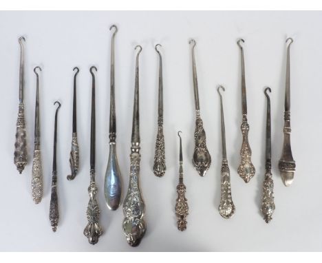 A collection of fourteen silver mounted button hooks