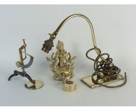 A collection of brassware, including a model of Shiva, brass postal scales, a lamp, a brass and enamel paperweight