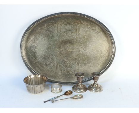 A hallmarked silver bowl, a pair of candlesticks, a napkin ring, a spoon, and a silver plated oval tray and spoon (7)