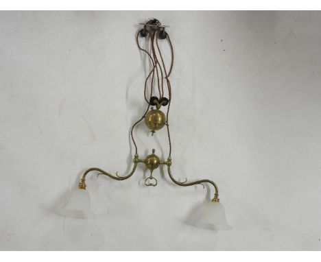 A brass two branch rise and fall ceiling light, approximately 70cm wide