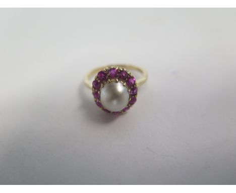 An 18ct yellow gold pearl and ruby ring, size K, approx 4 grams, in good condition, minor blemishes to pearl 