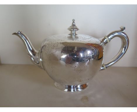 A Victorian silver teapot, with engraved decoration, approx 17.2 troy oz overall in good condition but with some small indent