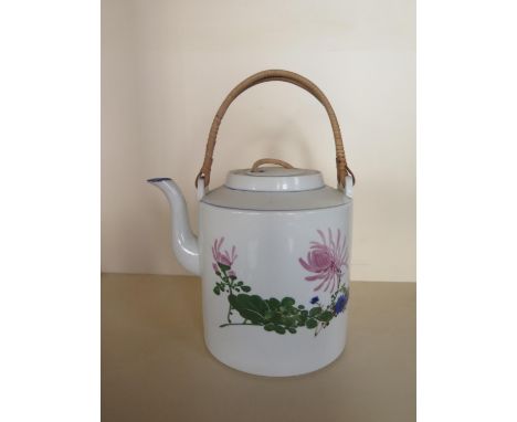 An oversized oriental teapot with floral decoration, 20cm tall, small chip to lid and cracks to body , otherwise generally go
