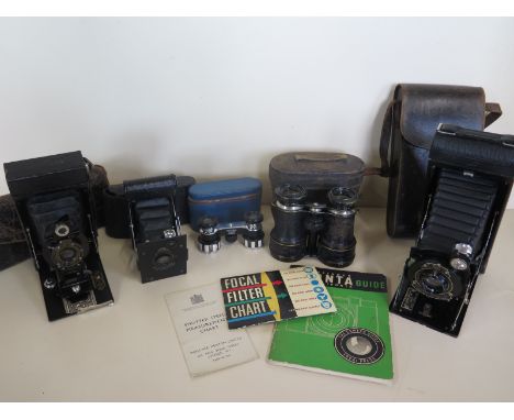A Kodak vest pocket camera, Kodak No3 folding camera, Kodak 116 folding camera, together with two pairs of Opera glasses 