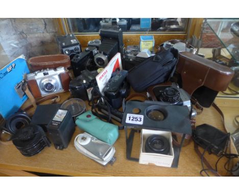 A collection of vintage cameras and attachments 