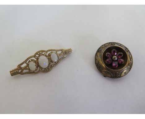 A 9ct yellow gold three stone opal brooch, 42mm long, approx 4.4 grams, and a gilt metal mourning brooch, both generally good