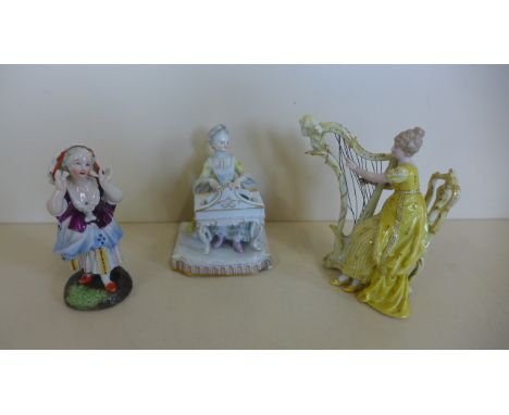 A Meissen figure of a lady playing the piano, 12cm tall, two other figures, Meissen figure has chips to base and some lacewor