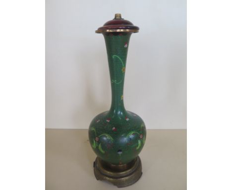 A Chinese early 20th century green cloisonne lamp base on a gilt metal stand, height 40cm, small dent to one side otherwise g