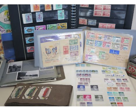 Four stamp albums, quantity of loose stamps and first day covers, albums of post cards, photographic and cigarette cards 