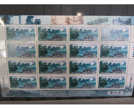 Four albums of WWII commemorative stamps and first day covers, stamps unused 