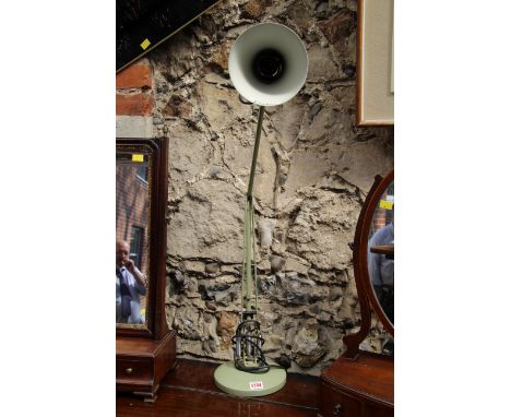 A green anglepoise lamp. 