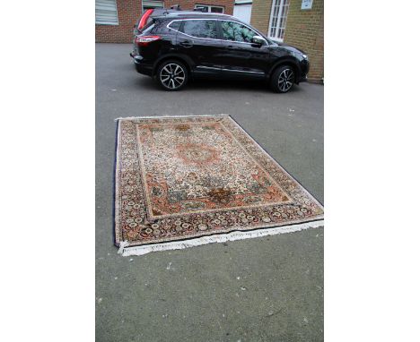 An Indian silk floral carpet, with large central medallion ivory field with animal cartouche detail, 266 x 185cm.     Conditi