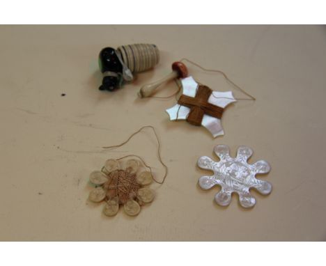 Of sewing interest: a novelty cat reel case; together with two mother of pearl winders; another similar ivory example; and an