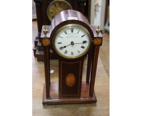 An Edwardian mahogany and inlaid 1000 day electric portico clock, by Eureka Clock Co Ltd, 36cm high.    Condition Report:  Ap