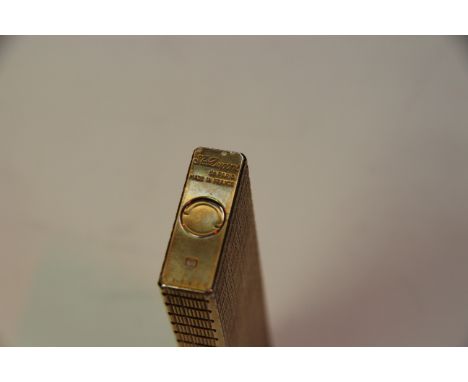 An oversized Dupont gilt lighter, 14cm long. 