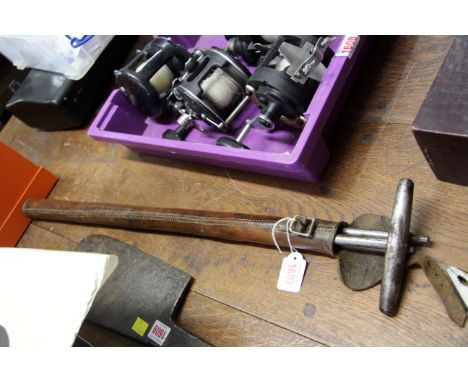 A leather cased steel agricultural tool, in three parts. 
