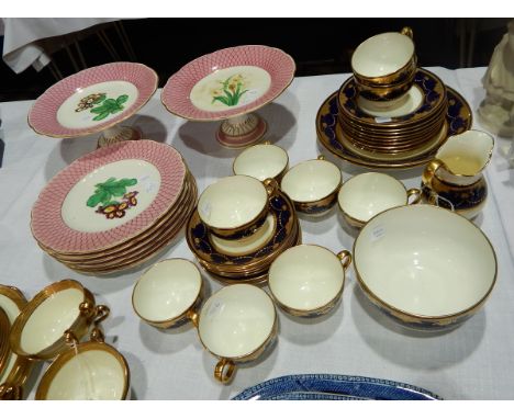 A Minton china part tea service with tooled and jewelled gilt borders, on a blue band and a Victorian china dessert service, 