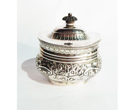 A Victorian silver tea caddy, the hinged cover with ebony finial, with overall repousse decoration, London 1899, 6oz approx.,