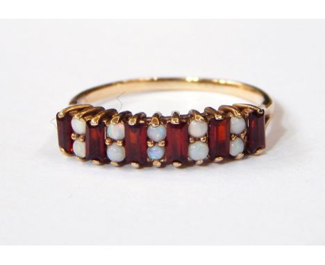 A 9ct gold, garnet and opal half-hoop ring set rectangular garnets alternating with pairs of opals 