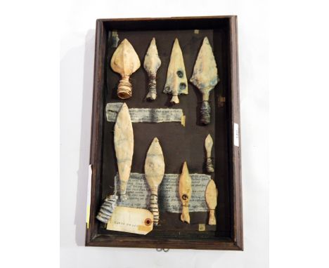 A wall plaque, ceramic reproduction spear heads and arrows 