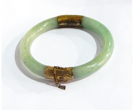 A jade circular hinged bangle with gilt mounts 