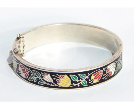 A sterling silver and enamel bangle, scrolling floral decorated to a black ground 