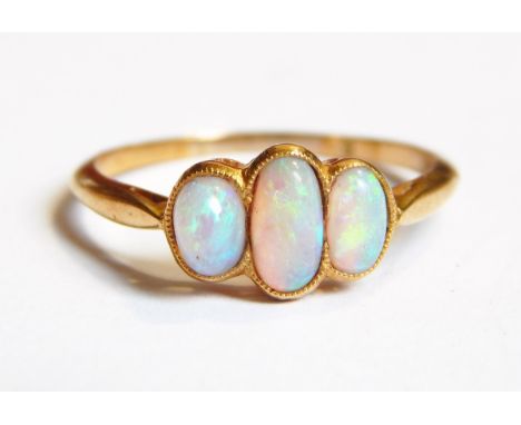 A gold three-stone opal ring marked 18ct 